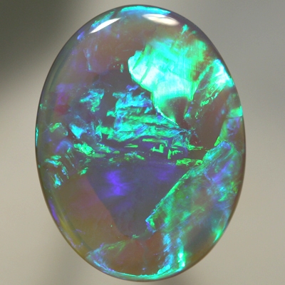SOLID SEMI BLACK OPAL Large opal with rolling flashes of neon fire. SEE VIDEO